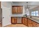 Open kitchen with stainless appliances, granite countertops, and wooden cabinets at 5195 Stefan Ridge Way, Buford, GA 30519