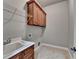 Functional laundry area features a white utility sink, wood cabinets, and wire shelving at 5195 Stefan Ridge Way, Buford, GA 30519
