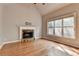 Light-filled living room with hardwood floors, stone fireplace and bright window at 5195 Stefan Ridge Way, Buford, GA 30519
