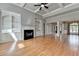 Open living room with coffered ceilings, hardwood floors, fireplace, and built-in shelving at 5195 Stefan Ridge Way, Buford, GA 30519