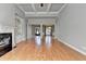 Spacious living room features coffered ceilings, hardwood floors, and a cozy fireplace at 5195 Stefan Ridge Way, Buford, GA 30519