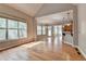 Bright living room with hardwood floors and large windows overlooking backyard at 5195 Stefan Ridge Way, Buford, GA 30519
