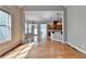 Sun-drenched living room featuring hardwood floors and an open layout to kitchen at 5195 Stefan Ridge Way, Buford, GA 30519