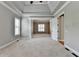 Airy main bedroom showcasing trey ceilings, neutral colors, and soft carpeting at 5195 Stefan Ridge Way, Buford, GA 30519