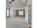 Large main bedroom enhanced by tray ceiling, decorative pillars, and soft carpet at 5195 Stefan Ridge Way, Buford, GA 30519