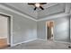 Open main bedroom features tray ceilings, access to other rooms, and neutral carpeting at 5195 Stefan Ridge Way, Buford, GA 30519