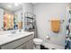 Bright bathroom featuring a gray vanity, sleek fixtures, and black metal shelving at 1702 Prospect Way, Conyers, GA 30094