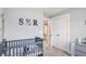 Bedroom with white trim and doors, and a gray crib at 1702 Prospect Way, Conyers, GA 30094