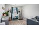 Bedroom with a changing table, plush chair, blue accents, and a patterned rug at 1702 Prospect Way, Conyers, GA 30094
