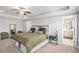 Spacious bedroom featuring a trey ceiling, fan, and a view into the bathroom at 1702 Prospect Way, Conyers, GA 30094