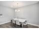 Bright dining room features hardwood floors, modern chandelier, and a white marble table at 1702 Prospect Way, Conyers, GA 30094