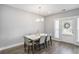 Bright dining room features hardwood floors, modern chandelier, and access to the outdoor area at 1702 Prospect Way, Conyers, GA 30094