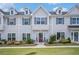Inviting townhome with well-maintained landscaping, gray siding, dark shutters, and a vibrant red door at 1702 Prospect Way, Conyers, GA 30094