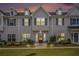 Charming townhome featuring a red front door, gray siding, and well-manicured landscaping at 1702 Prospect Way, Conyers, GA 30094