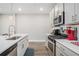 Well-equipped kitchen with stainless steel appliances, stylish cabinets, and white quartz countertops at 1702 Prospect Way, Conyers, GA 30094