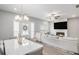 Open concept living room featuring a fireplace, TV, and a view of the dining area at 1702 Prospect Way, Conyers, GA 30094
