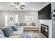Cozy living room features a fireplace, large TV, fan, and comfortable sectional couch with decorative pillows at 1702 Prospect Way, Conyers, GA 30094