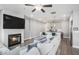 Open-concept living space includes a fireplace, flat-screen TV, and an adjacent modern kitchen at 1702 Prospect Way, Conyers, GA 30094