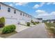 Rear view of townhomes featuring attached garages and well-maintained landscaping at 1702 Prospect Way, Conyers, GA 30094