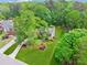 Aerial view of a home with a large lawn surrounded by lush greenery and mature trees at 22 Oakwood Hills Dr, Suwanee, GA 30024
