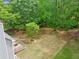 Aerial view of a backyard featuring a lush lawn, wooden decks, mature trees, and a secluded area for serene outdoor enjoyment at 22 Oakwood Hills Dr, Suwanee, GA 30024