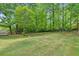 Well-manicured backyard with plenty of room to play and surrounded by mature trees providing shade and seclusion at 22 Oakwood Hills Dr, Suwanee, GA 30024