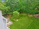 Aerial view of a backyard featuring a lush lawn, wooden decks, mature trees, and a secluded area for serene outdoor enjoyment at 22 Oakwood Hills Dr, Suwanee, GA 30024