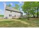 Exterior view of home with a spacious backyard and two-level deck for outdoor enjoyment at 22 Oakwood Hills Dr, Suwanee, GA 30024