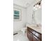 Bathroom featuring a wood vanity, window and toilet at 22 Oakwood Hills Dr, Suwanee, GA 30024