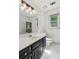Bright bathroom featuring a black vanity, modern lighting, and a walk-in shower at 22 Oakwood Hills Dr, Suwanee, GA 30024