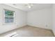 Empty bedroom featuring carpet flooring and a large window at 22 Oakwood Hills Dr, Suwanee, GA 30024