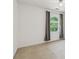 Empty bedroom featuring neutral carpet and a arched window with curtains at 22 Oakwood Hills Dr, Suwanee, GA 30024