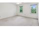 Spacious empty bedroom with carpet flooring and multiple windows at 22 Oakwood Hills Dr, Suwanee, GA 30024