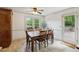 Bright dining room featuring hardwood table, a ceiling fan, and access to outdoor patio at 22 Oakwood Hills Dr, Suwanee, GA 30024