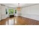 Traditional dining room with hardwood floors, bay window, chair railing, and a woven light fixture at 22 Oakwood Hills Dr, Suwanee, GA 30024