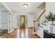 Elegant foyer featuring hardwood floors, a wooden staircase, and a decorative front door at 22 Oakwood Hills Dr, Suwanee, GA 30024
