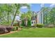Beautiful home with lush landscaping, green lawn, and classic architectural details at 22 Oakwood Hills Dr, Suwanee, GA 30024