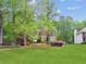 Traditional brick home with lush green lawn, mature trees, and well-maintained landscaping at 22 Oakwood Hills Dr, Suwanee, GA 30024