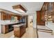 Traditional kitchen featuring wood cabinetry, an island cooktop, and white countertops at 22 Oakwood Hills Dr, Suwanee, GA 30024