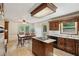 Traditional kitchen with a central island cooktop and an adjacent dining area at 22 Oakwood Hills Dr, Suwanee, GA 30024