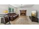 Cozy living room featuring a brick fireplace, plush seating, and a large window at 22 Oakwood Hills Dr, Suwanee, GA 30024