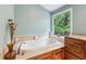 Main bathroom featuring a soaking tub with jets and a large window overlooking the yard at 22 Oakwood Hills Dr, Suwanee, GA 30024
