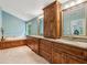 Main bathroom boasting double vanities, soaking tub, and wood cabinets at 22 Oakwood Hills Dr, Suwanee, GA 30024