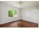 Cozy bedroom with original windows, hard wood floors, and light-toned wood paneling at 3367 Misty Valley Rd, Decatur, GA 30032
