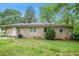 The exterior of the home shows a backyard view with trees and a large grassy lawn at 3367 Misty Valley Rd, Decatur, GA 30032