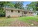Side view of home featuring brick exterior and green lawn at 3367 Misty Valley Rd, Decatur, GA 30032