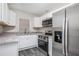 Stylish kitchen with stainless steel appliances, granite countertops, and gray-toned floors at 3367 Misty Valley Rd, Decatur, GA 30032
