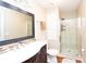 Updated bathroom featuring tile floors, a sleek vanity, a modern mirror, and a glass-enclosed shower at 3404 Vinings North Se Trl, Smyrna, GA 30080