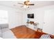 Well-lit bedroom with a sofa, hardwood floors, and a modern entertainment center at 3404 Vinings North Se Trl, Smyrna, GA 30080