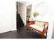 Inviting entryway features wood bench, storage, accent mirror and dark hardwood floors at 3404 Vinings North Se Trl, Smyrna, GA 30080